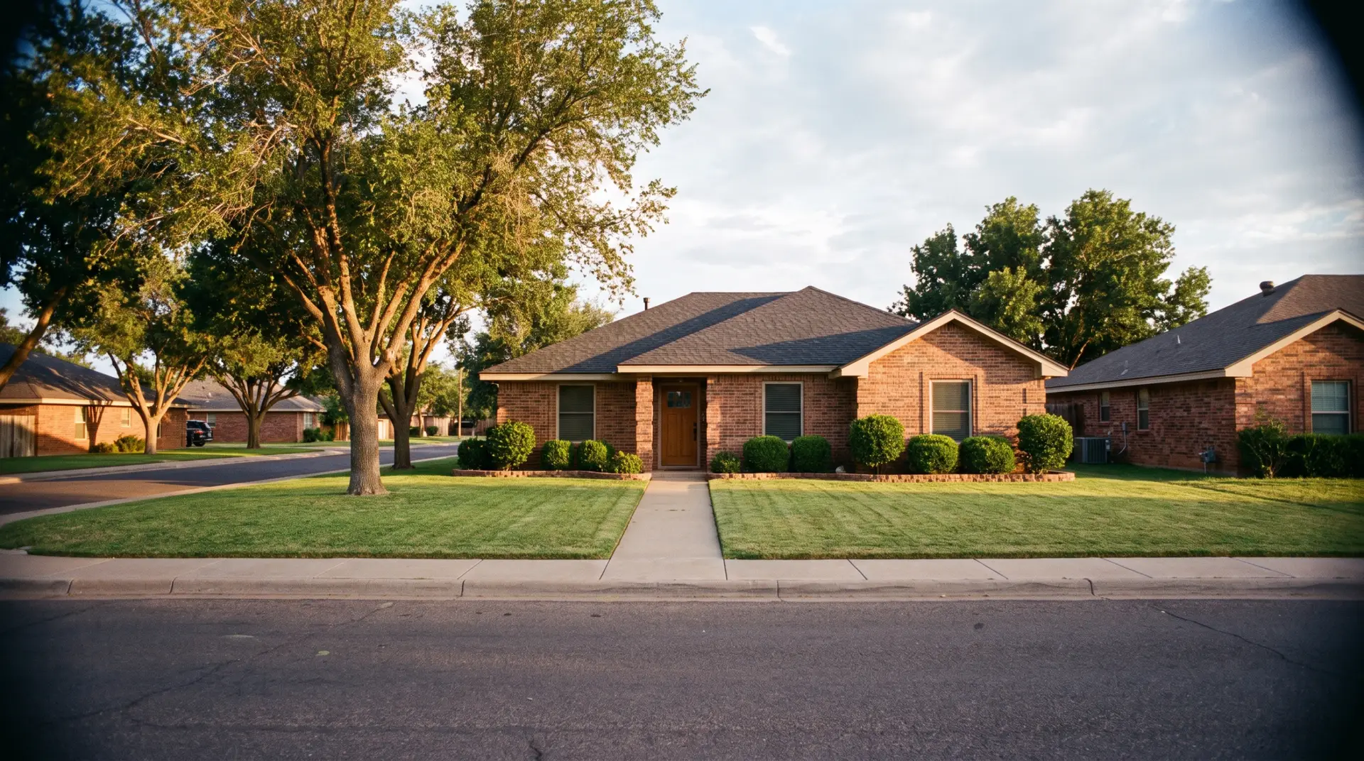 Curb appeal upgrades on a Lubbock home with new roof, clean driveway and green yard