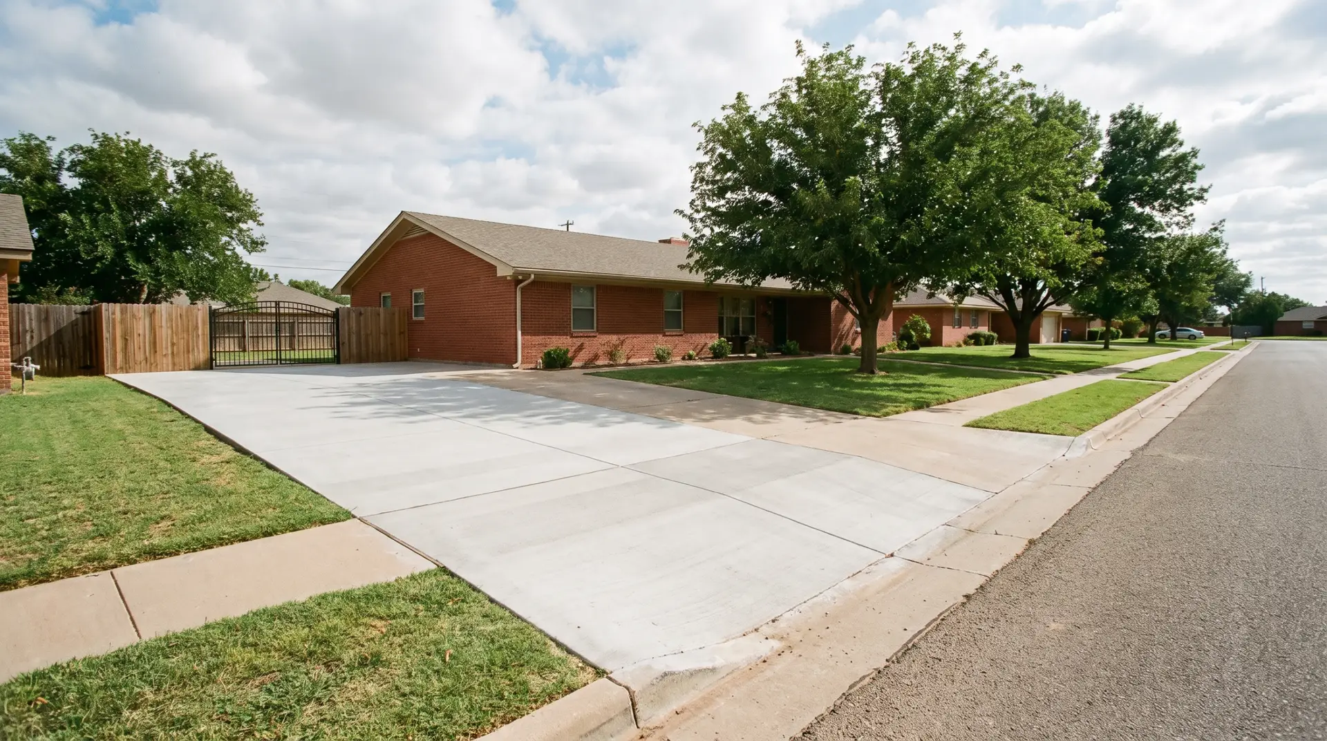 Saw-cut control joints in a new backyard concrete patio slab in Lubbock, Texas