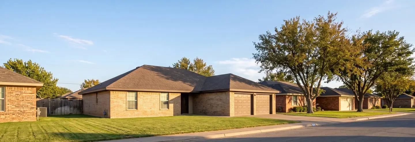 Levelland roofing contractor project: tan brick ranch home on a quiet Levelland, TX street with a new composition shingle roof
