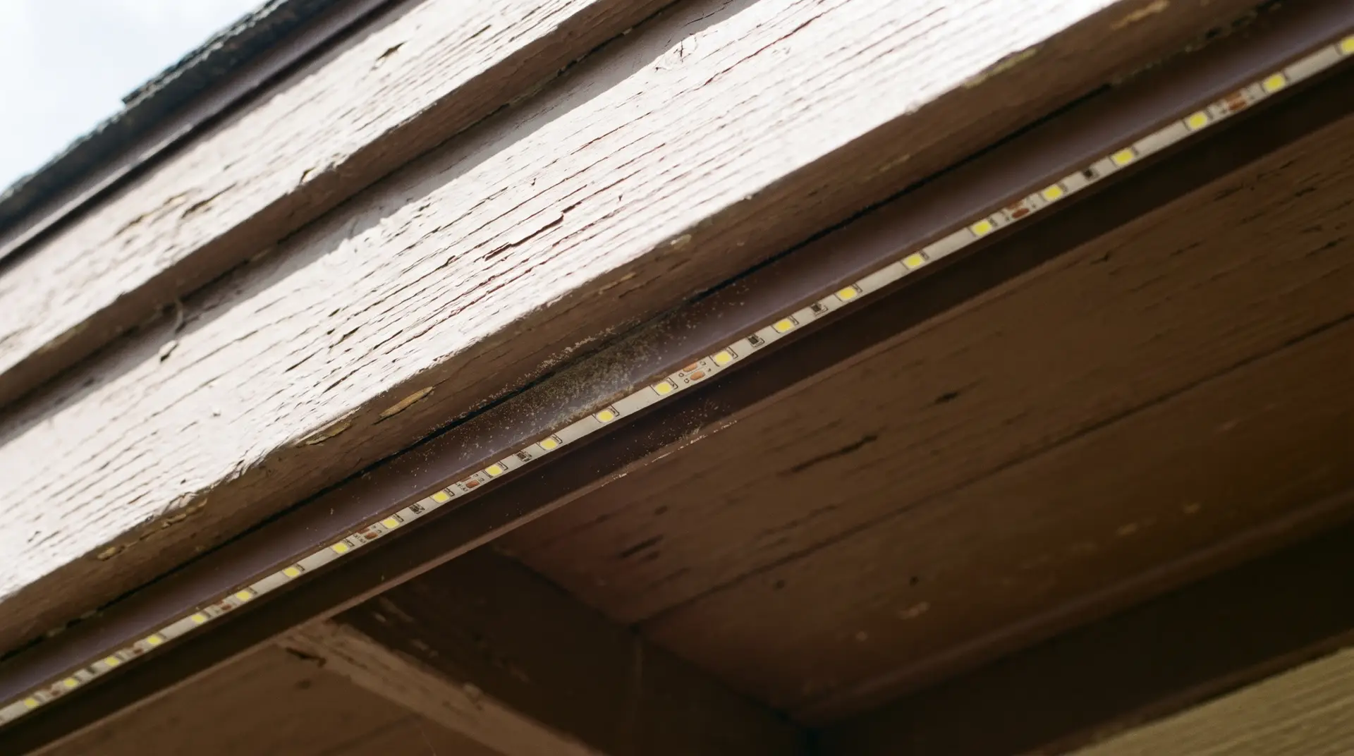 Color-matched aluminum light channel installed along fascia board under a drip edge