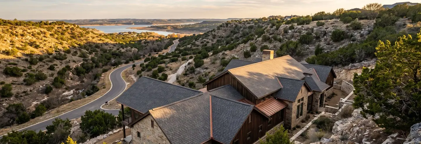 Ransom Canyon roofing contractor project: canyon-side stone and cedar home above the lake in Ransom Canyon, TX with a new roof