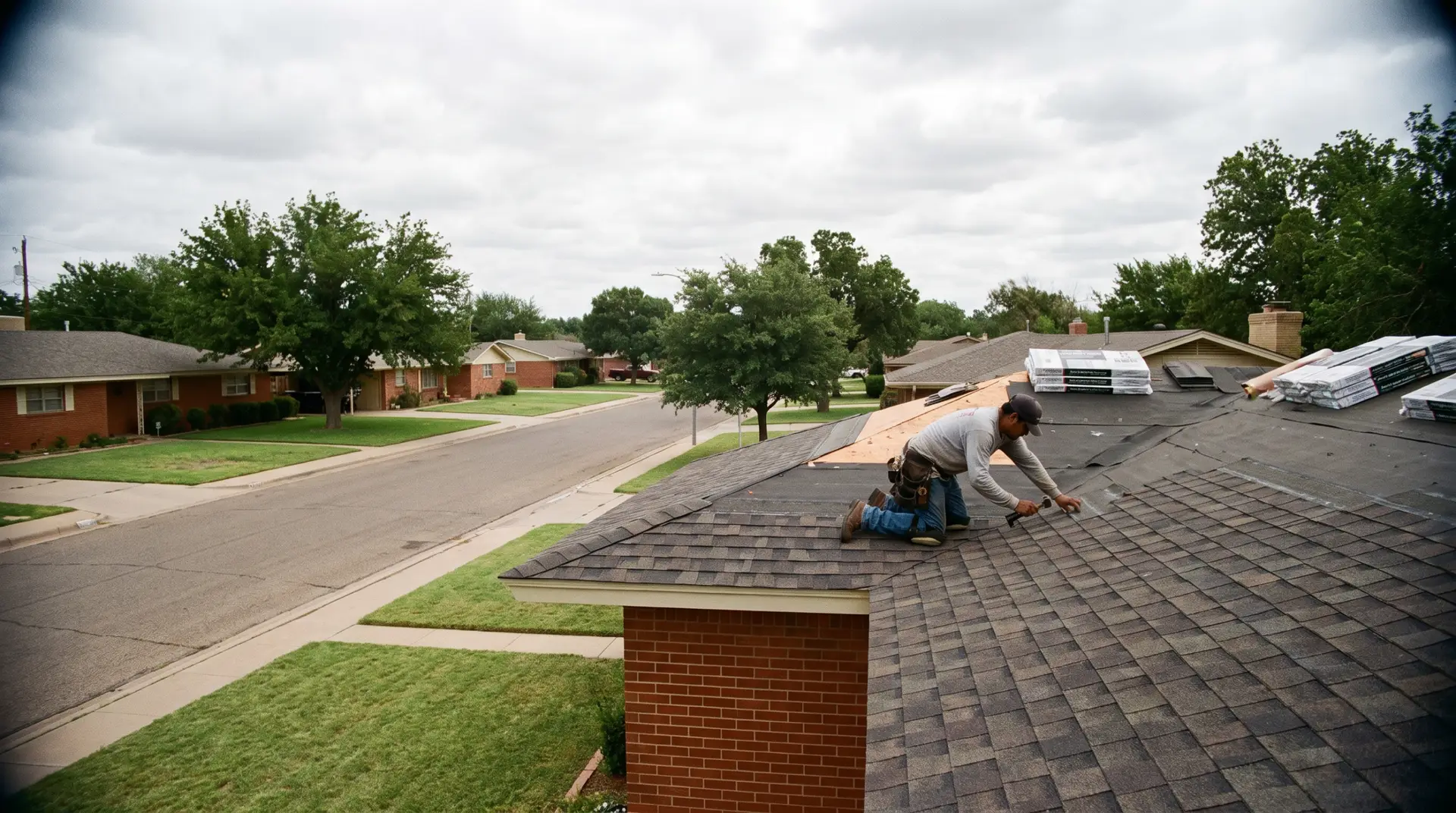 Weathered wood shingle colors on a red brick ranch home roof in Lubbock Texas